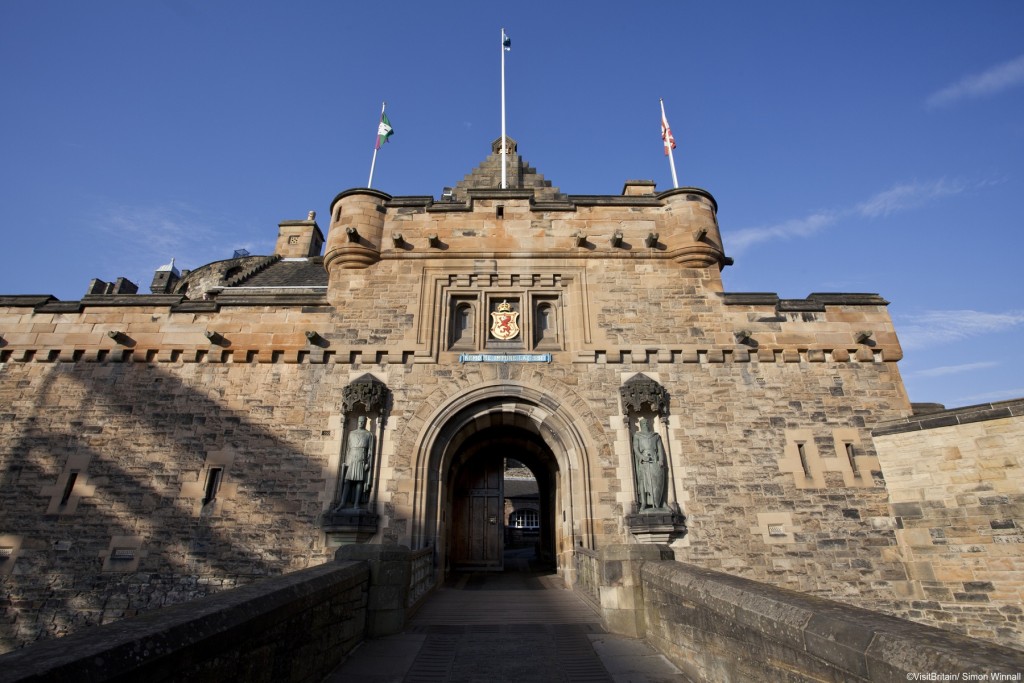 A day out in Edinburgh. Edinburgh castle, a historic stronghold on Castle Rock, dominating the city. A family outing, two adults and two children exploring the castle. The gatelodge and entrance walkway.