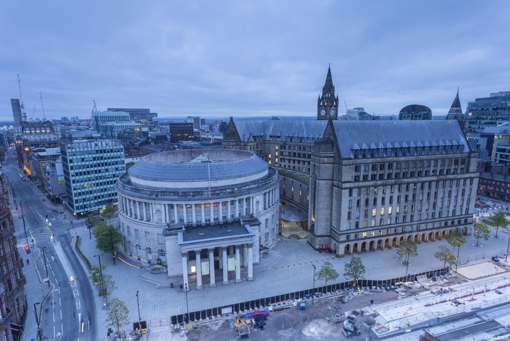View of St Peter's Square and the local landmark, Manchester Central Library and Manchester Town Hall at dusk.